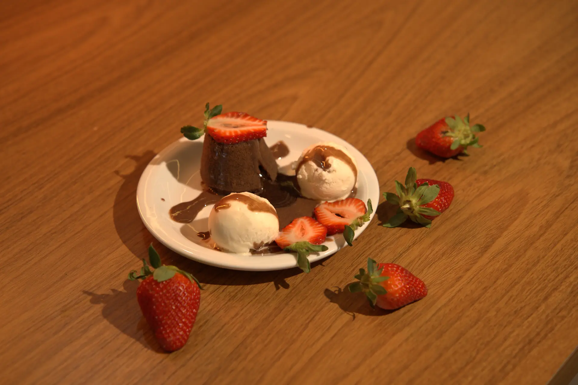 Petit gâteau com calda de chocolate escorrendo